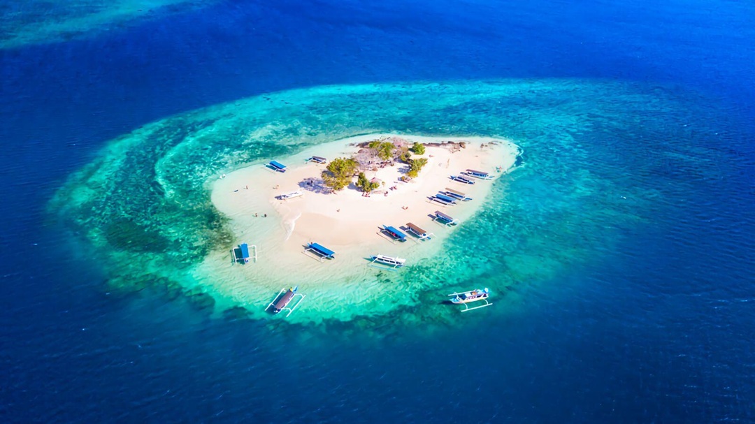 Aerial view of Gili Nanggu island with white sandy beach and turquoise water in Lombok Indonesia.