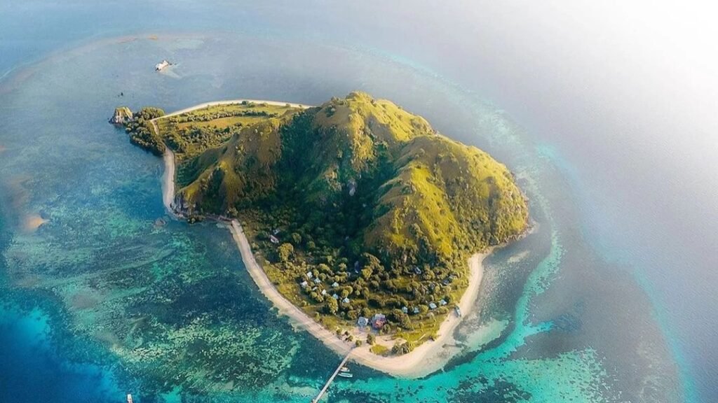 Aerial view of Komodo Island near Labuan Bajo with crystal clear turquoise water and tropical landscape in Indonesia