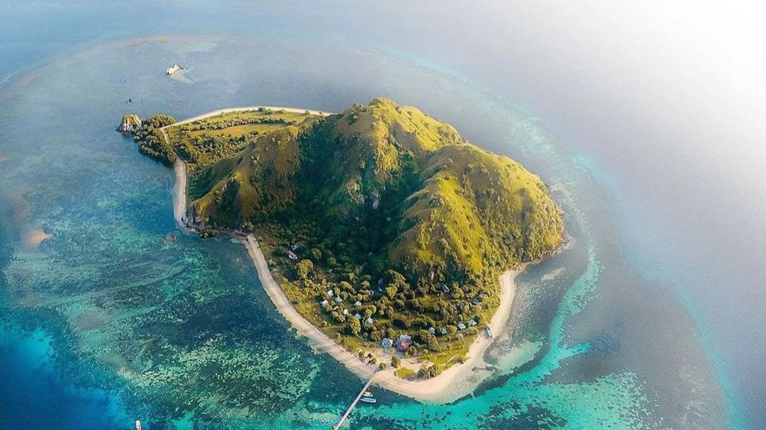Aerial view of Komodo Island near Labuan Bajo with crystal clear turquoise water and tropical landscape in Indonesia