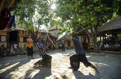 Traditional stick fighting performance by Sasak men in a traditional village in Lombok Indonesia.