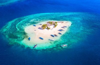 Aerial view of Gili Nanggu island with white sandy beach and turquoise water in Lombok Indonesia.